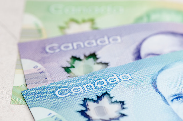 Close up of Canadian currency. Blue, purple, and green bills.
