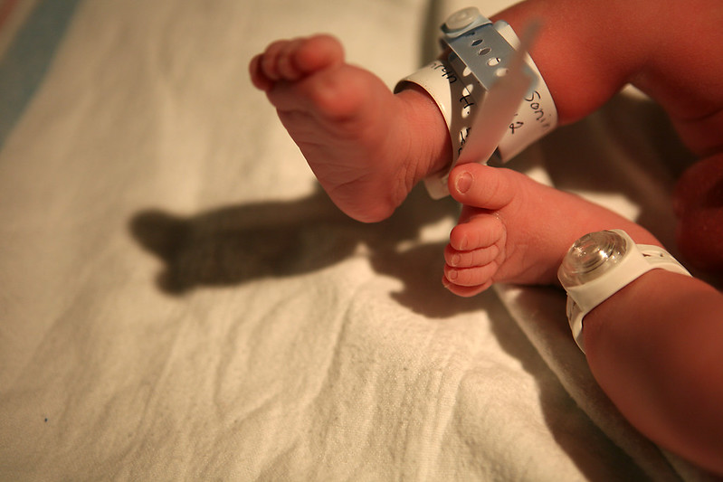 newborn baby feet with ankle bands