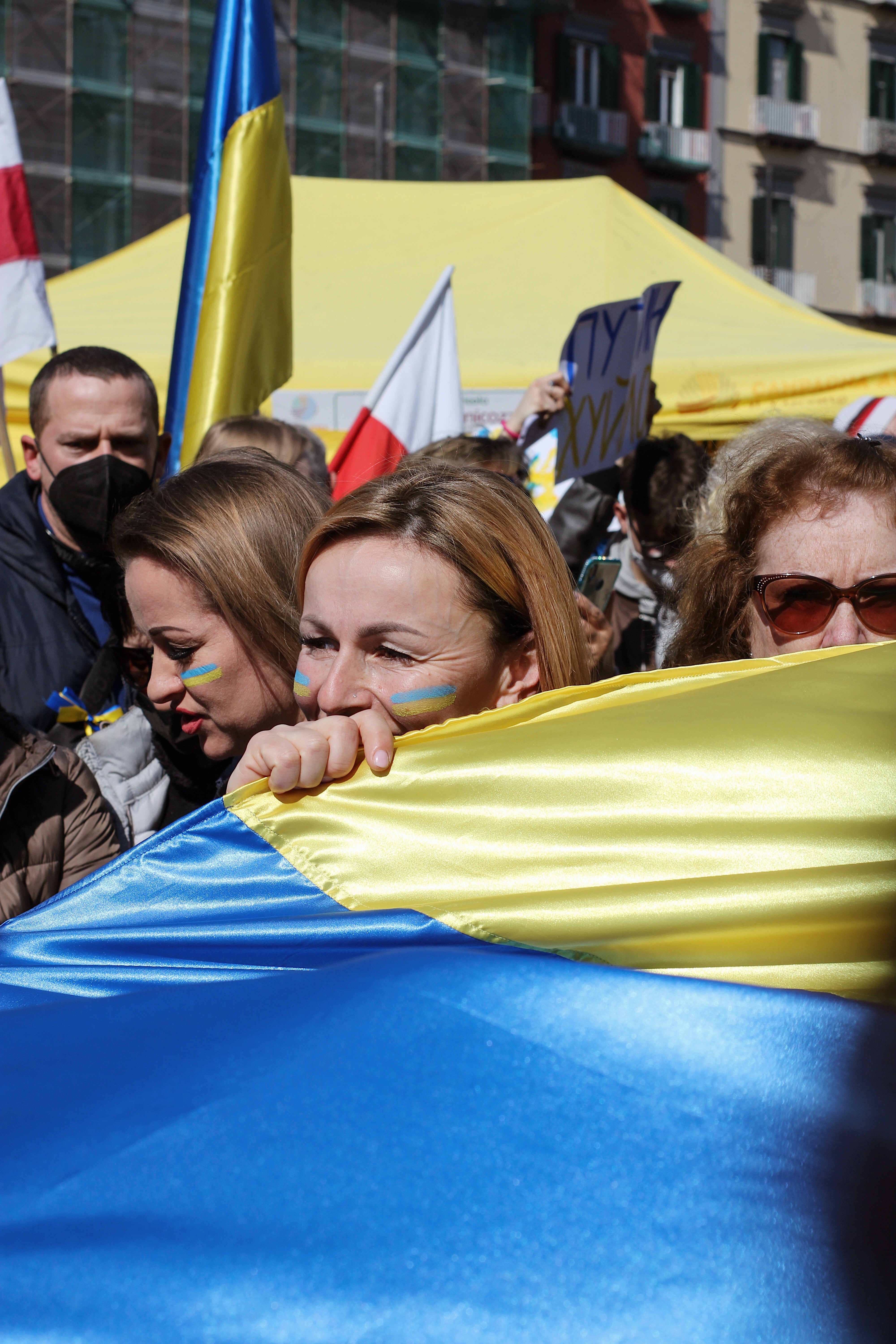 a woman holding the Ukrainian flag