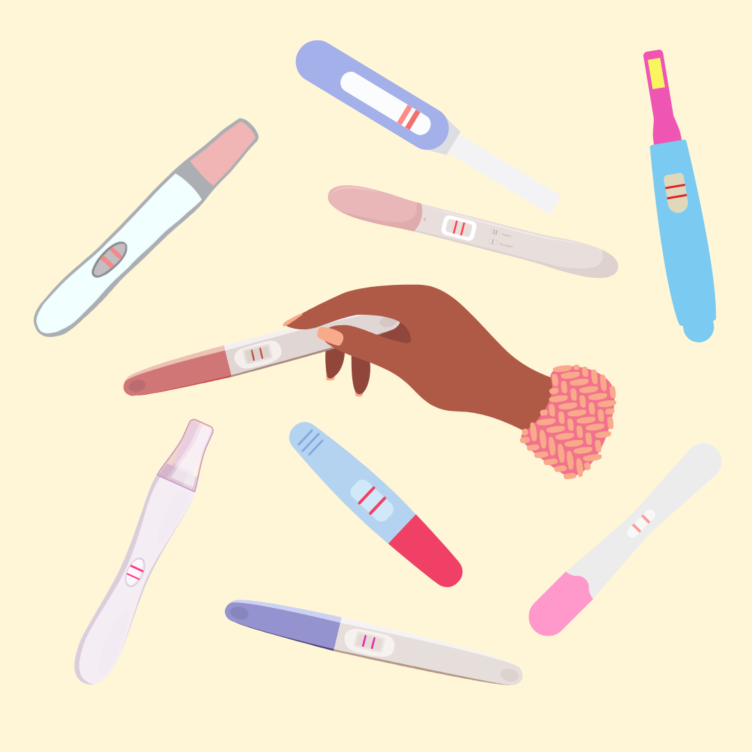 a hand holding a pregnancy test with many other pregnancy tests surrounding it