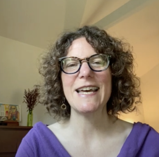 CGS Consultant Emily Galpern, with brown curly hair, glasses, and a purple top