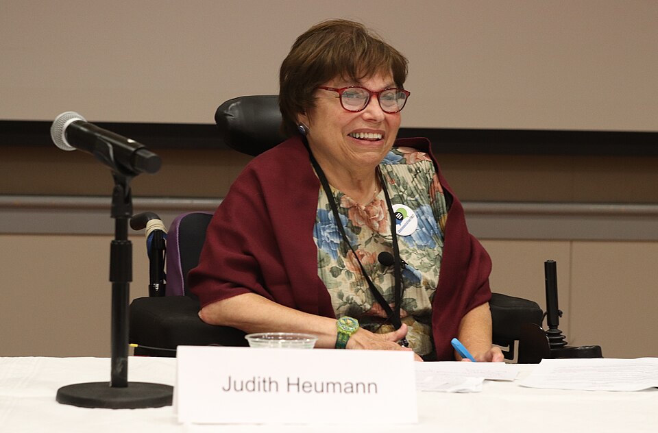 A photograph of Judith Heumann, as a panelist, ready to speak