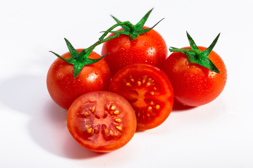four red tomatoes on a white background 