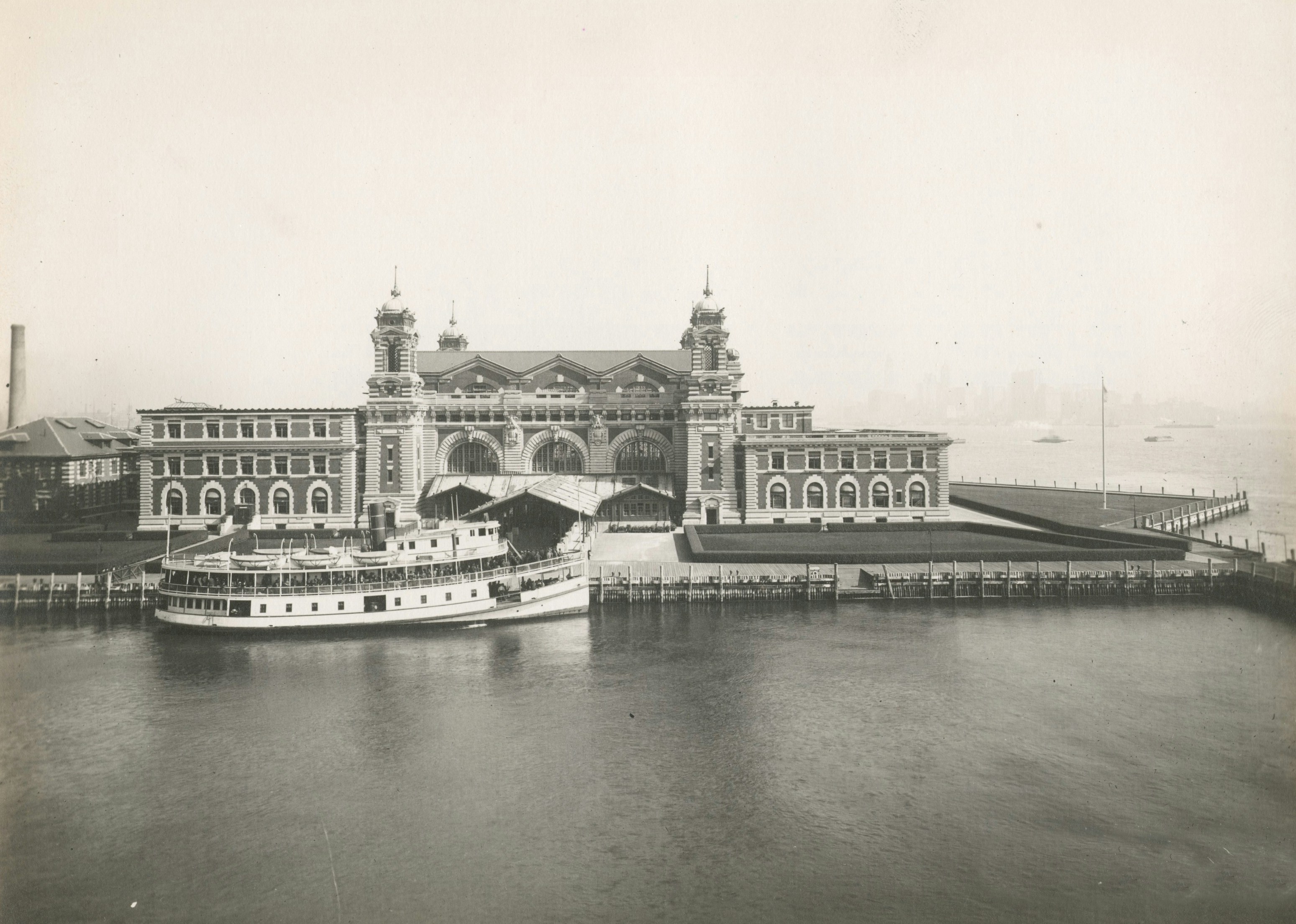 a grey and white photo of Ellis Island