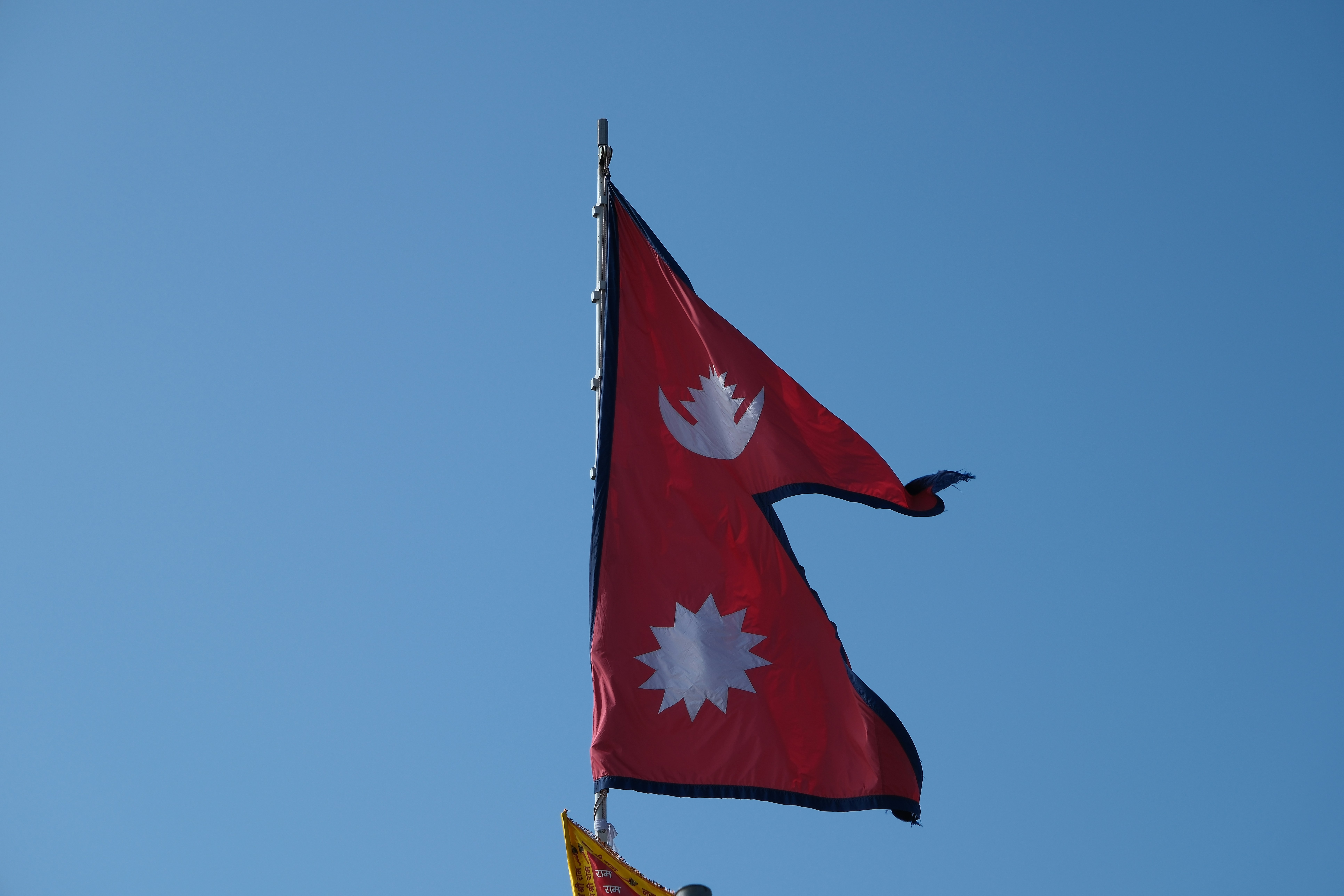 flag of Nepal with blue sky in the background