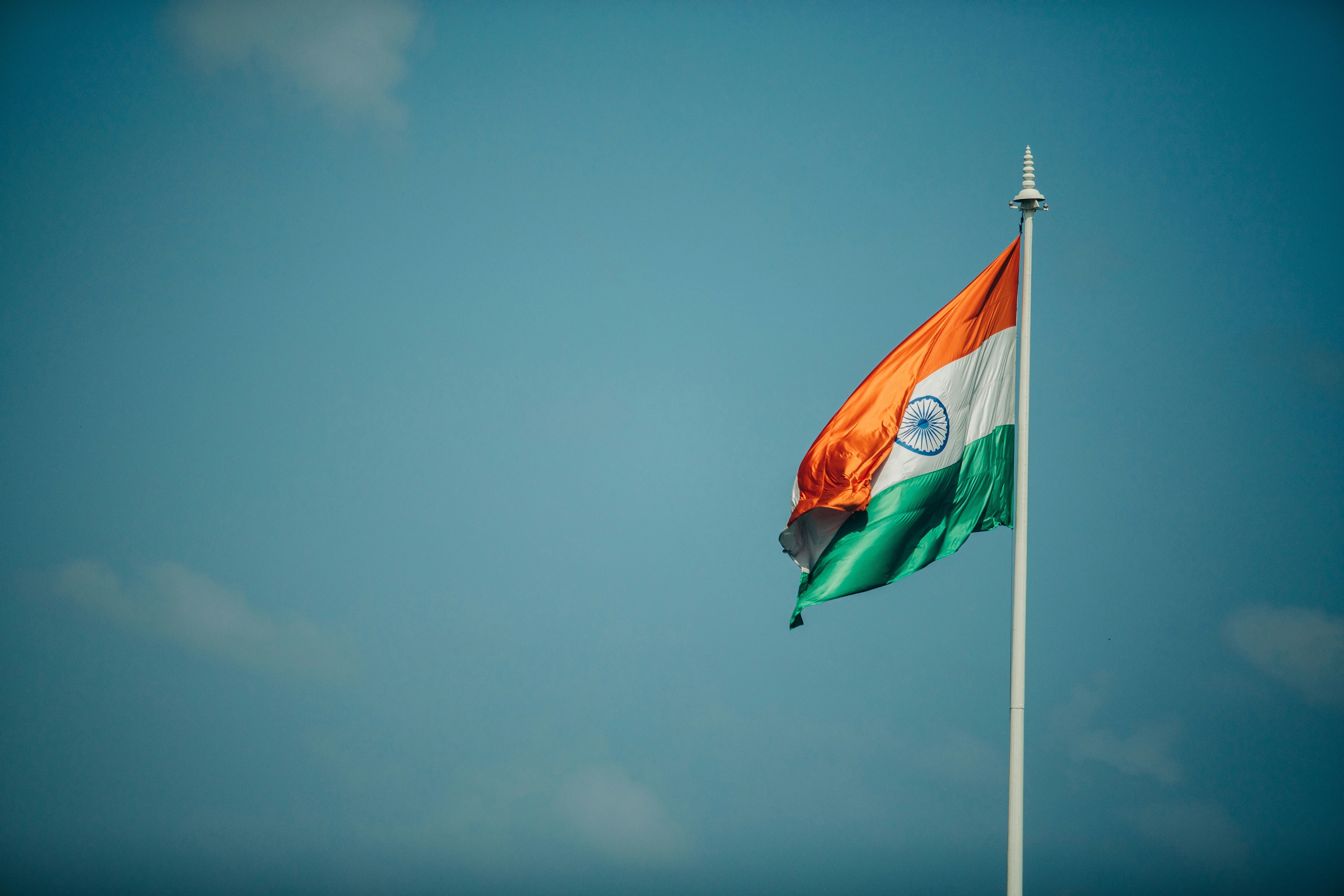 photo of the Indian flag with blue sky in the background