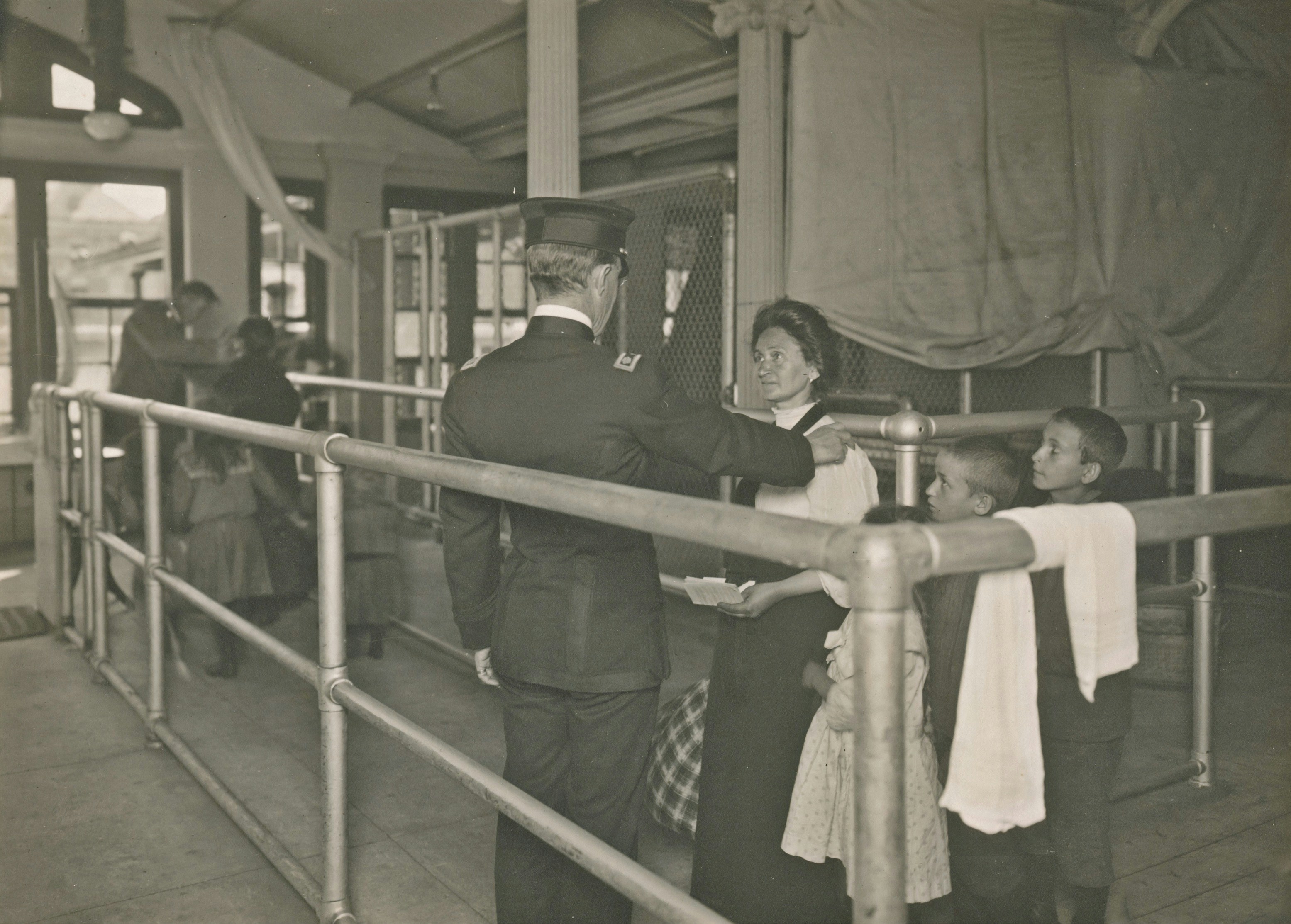 immigrants at Ellis Island undergoing medical inspection