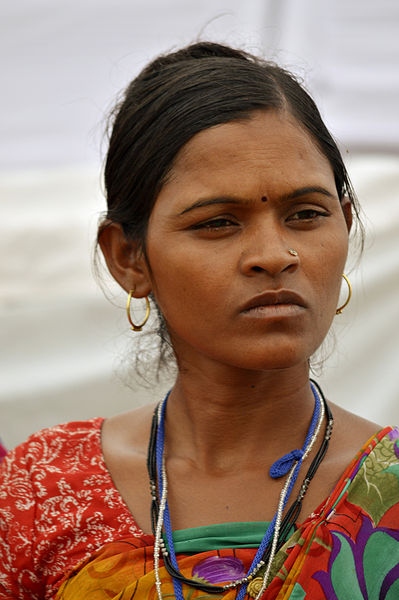 An Indian woman gazes into the distance and appears to be thinking.