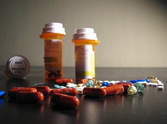 pill bottles with pills spilled out in front