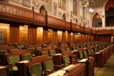 Empty chamber, featuring the seats for House of Commons members.