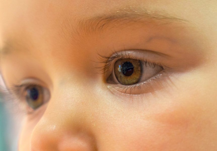 Close up of a baby's eyes staring into the distance.
