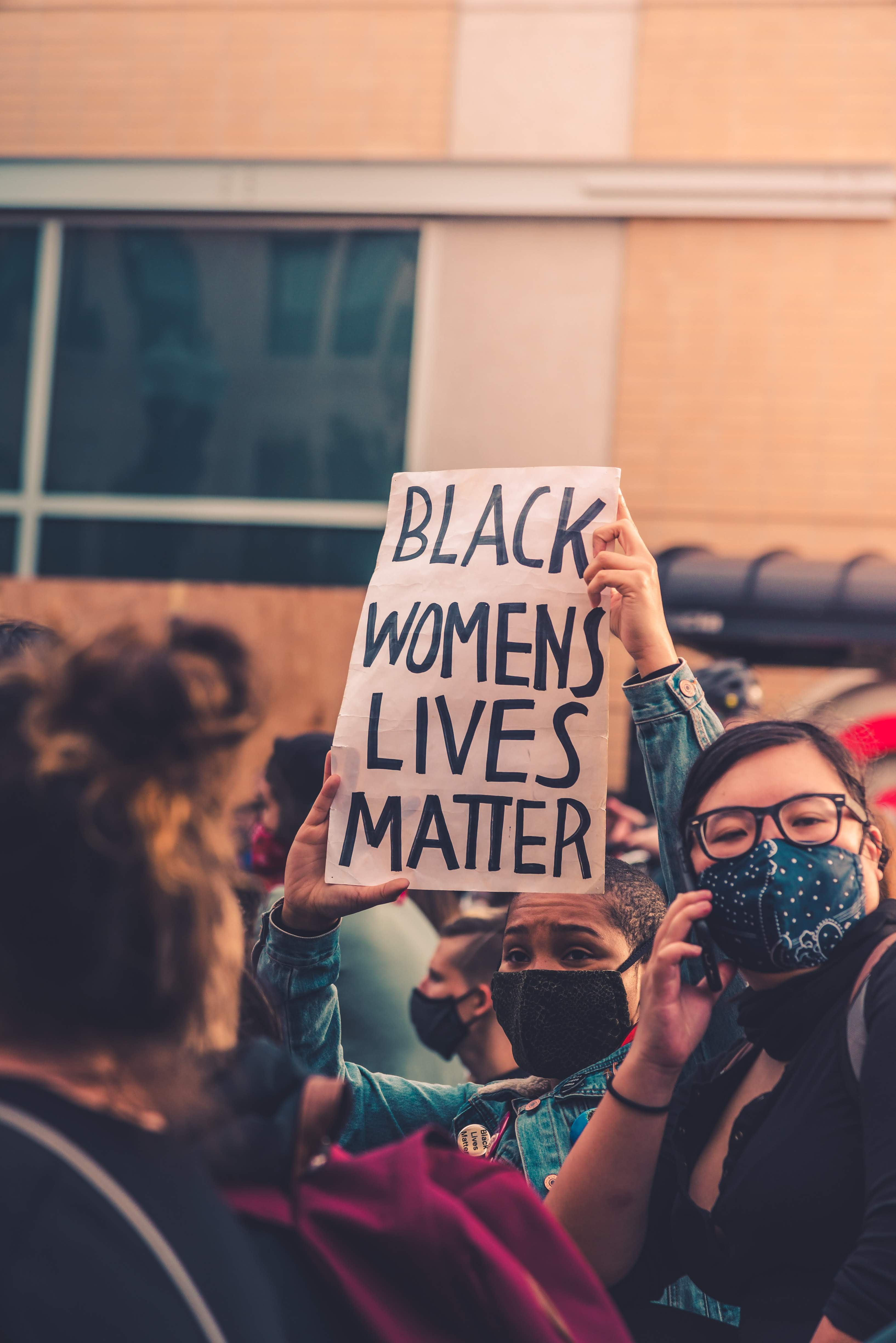 'black women's lives matter' on a sign during a protest