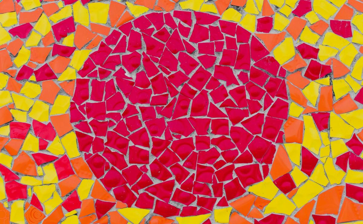 Tile mosaic with red circle on a yellow and orange background