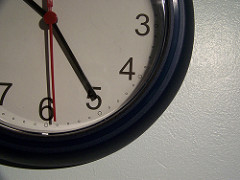 A clock appears hanging on wall, with its hands showing the time 10:25