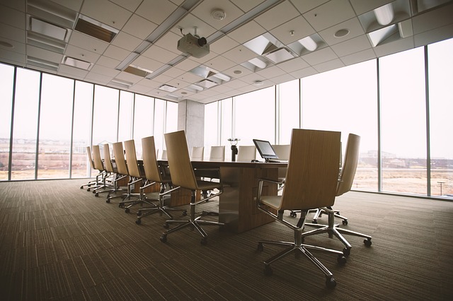 Beige conference room surrounded by glass windows.