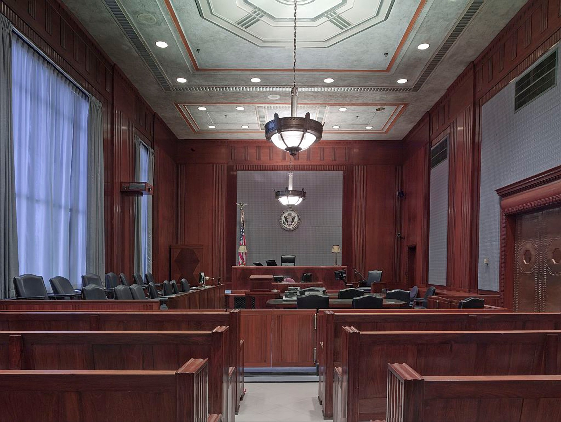 Interior of an empty courthouse, viewed in the perspective of any observer.