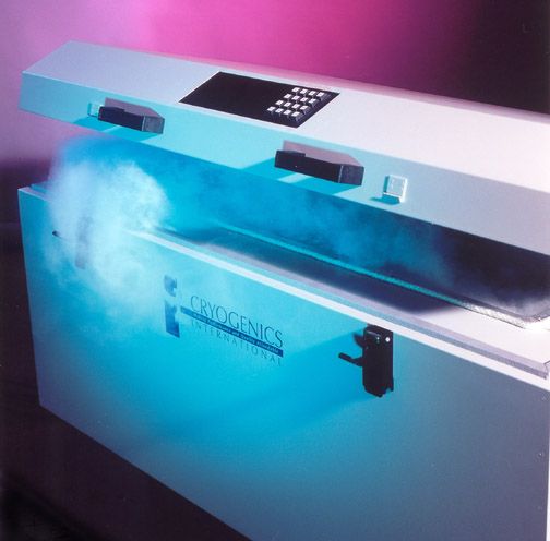 A futuristic-looking freezer illuminated in blue and pink light opens to reveal white vapor. The freezer is labeled "Cryogenics International."