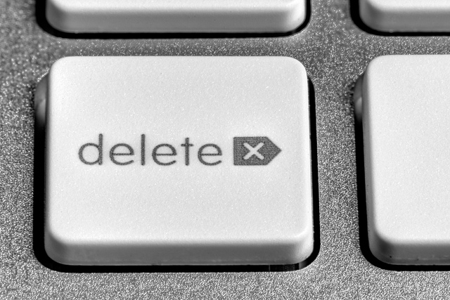 close up of a white delete key bordered by silver