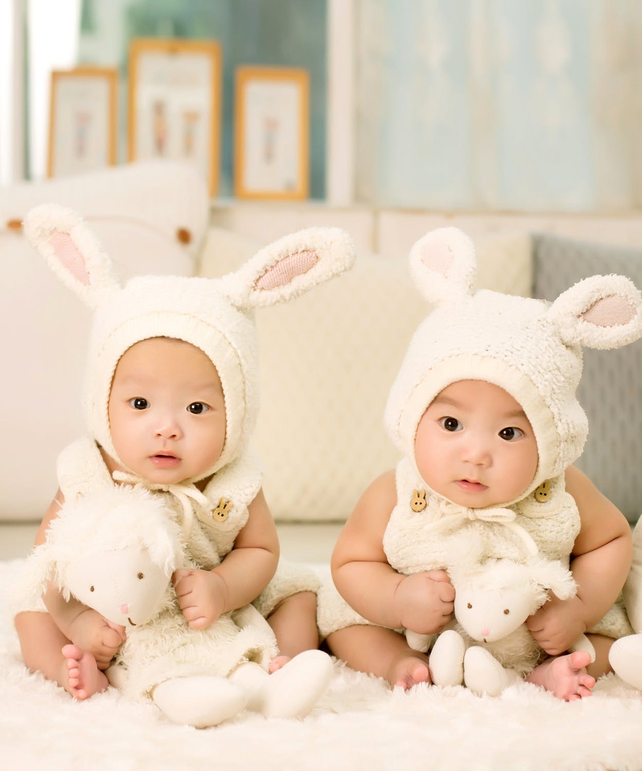Two babies wearing hats