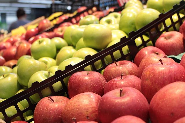 Apples are displayed in a grocery market's produce stand.