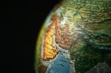Globe featuring the continent of Asia, with transnational arrows.