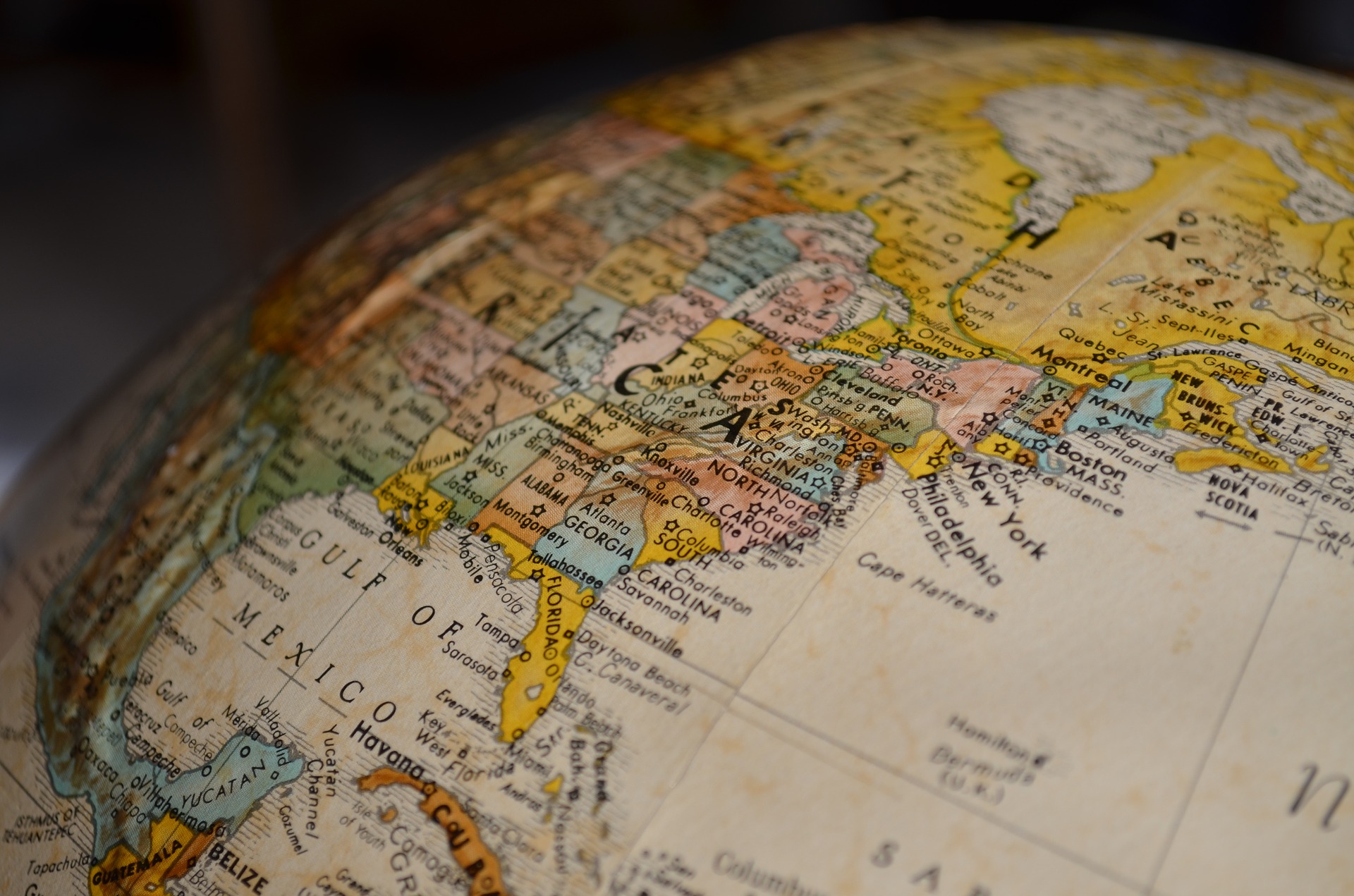 Close up photo of a globe, turned on its side to display the United States and Mexico.