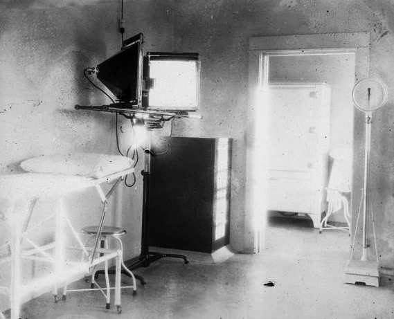 Black and white photo of an old hospital room. 