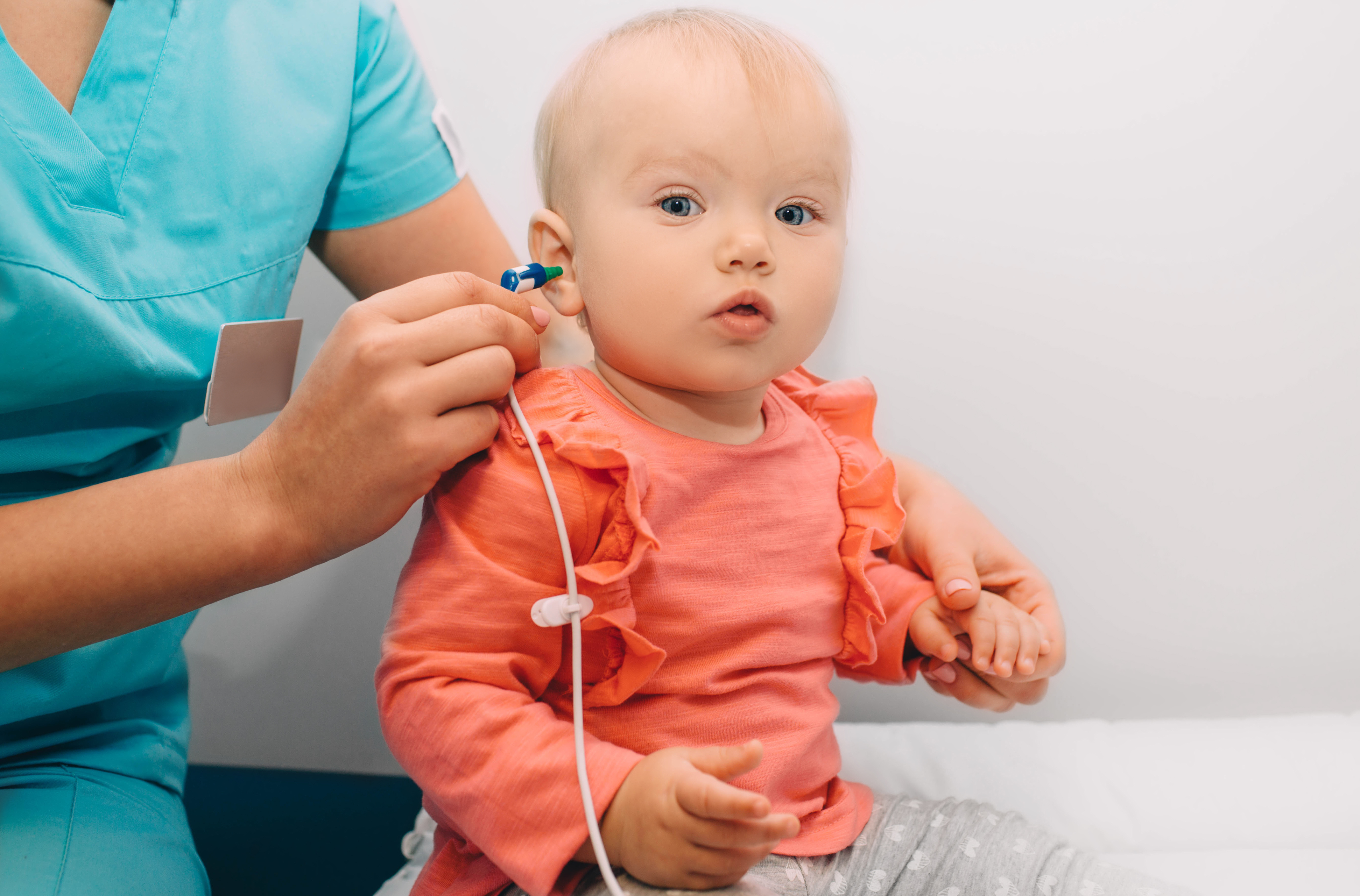 A nurse checking a baby's hearing