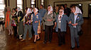 A group of women raning in age, with their heads covered by scarves,m arching in line in a building. These women are the Grandmothers of Plaza de Mayo.