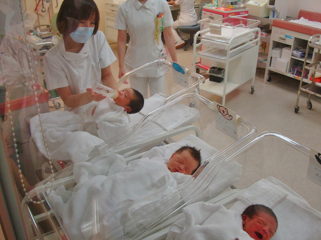 Many babies in cots