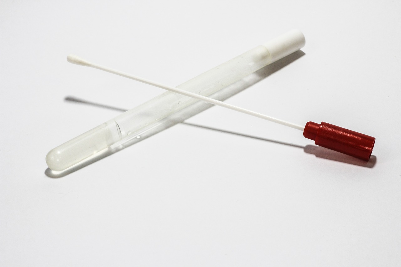 A cotton swab rests on a container.