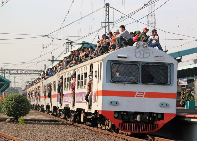 Men crowded into and on a train in India