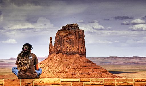 A Navajo girl in front of a Mesa