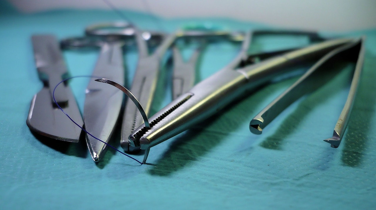 Surgical equipment is laid out on a tray