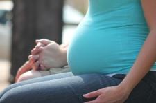 pregnant woman holding hands