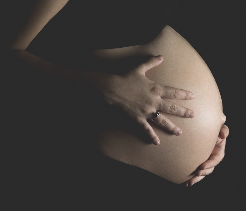 Pregnant woman holding her stomach