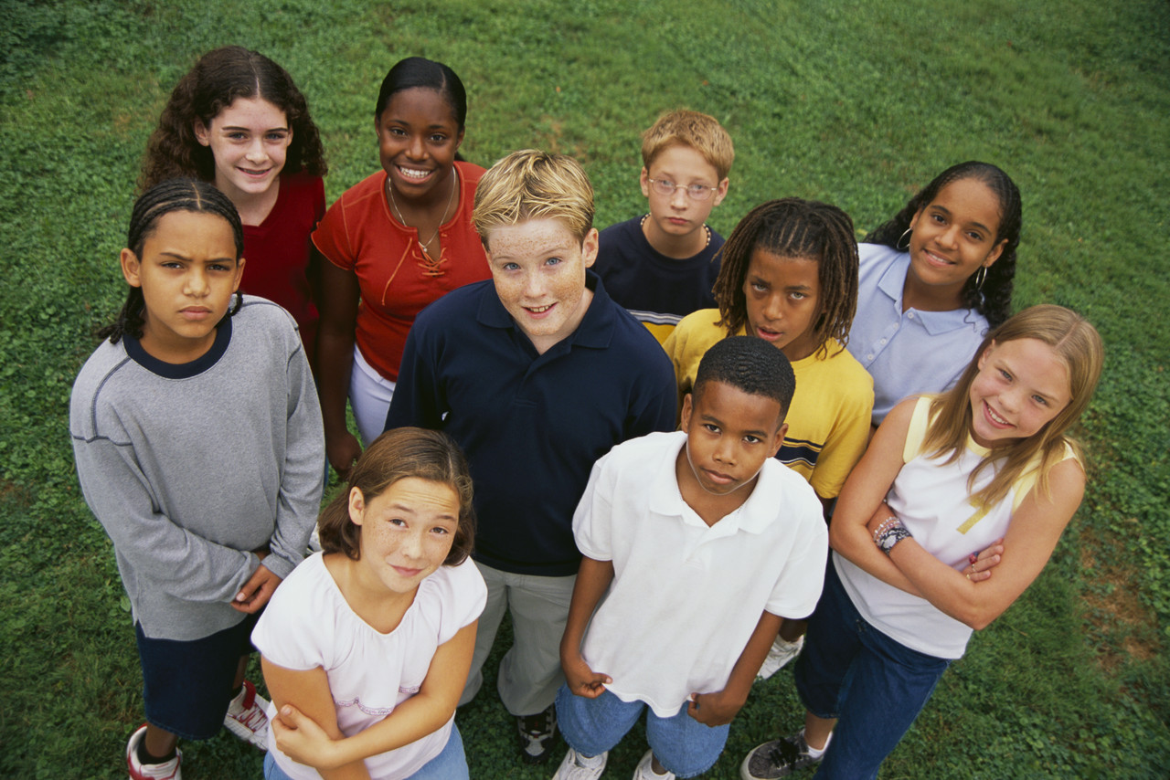Diverse group of children standing in grass