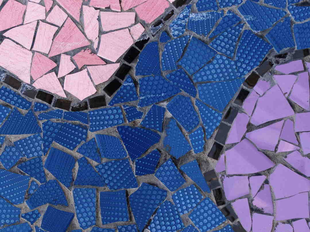 tile mosaic with pink and purple shapes on a blue background