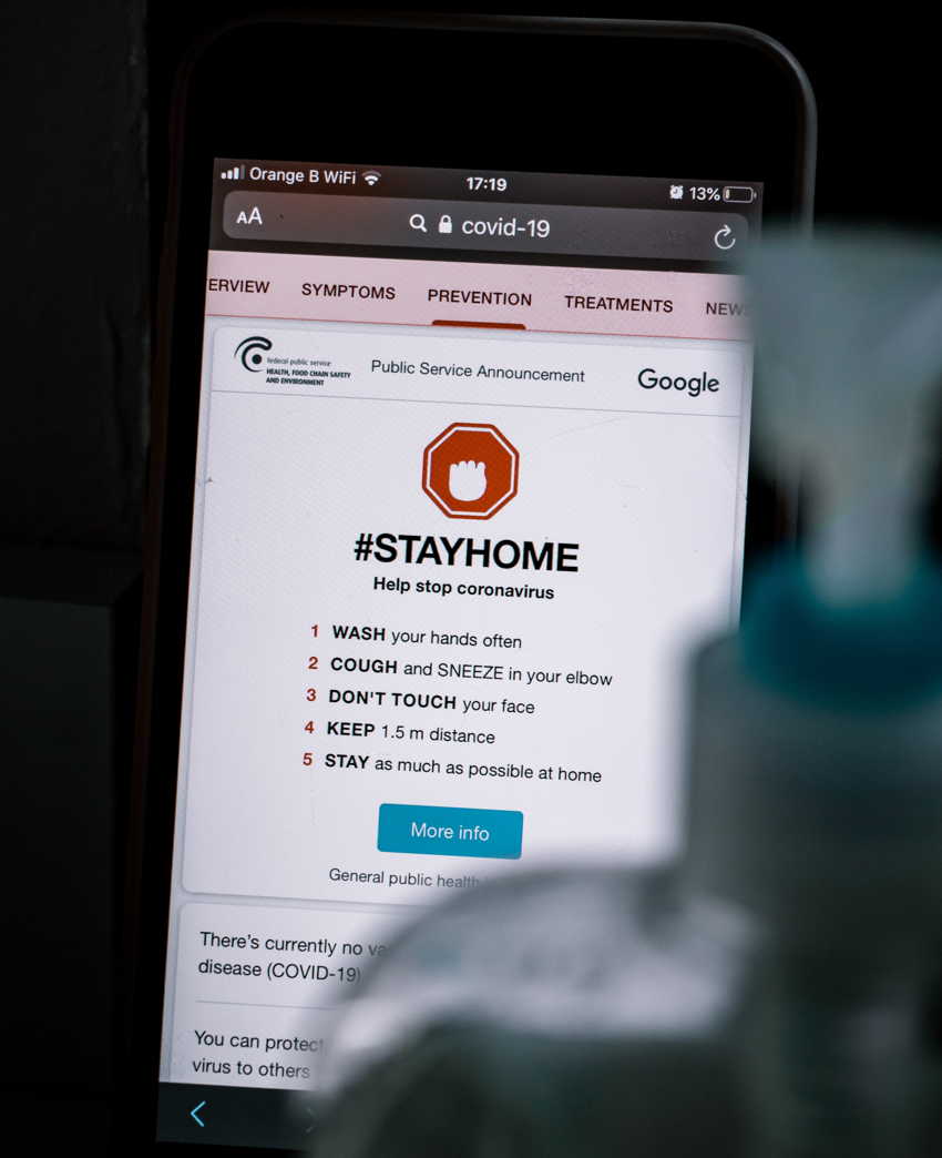 A smartphone with Stay Home instructions