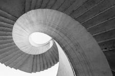 Black and white image of a winding staircase.