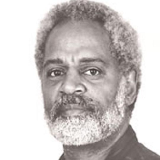 a black and white photo of a man with white and grey hair