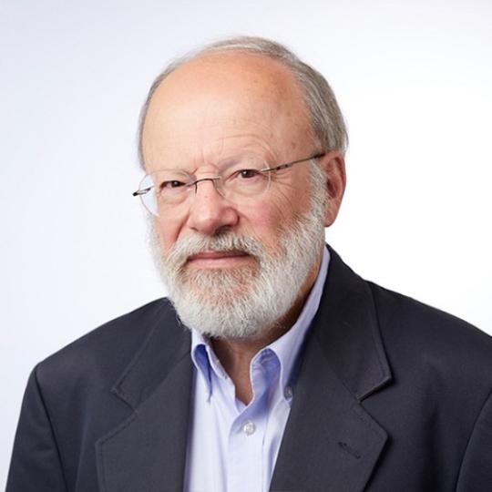 a white man in glasses and a suit 