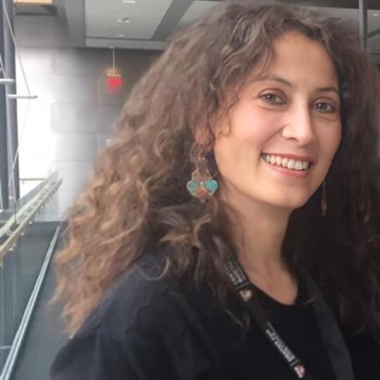 a photo of a white woman with curly brown hair