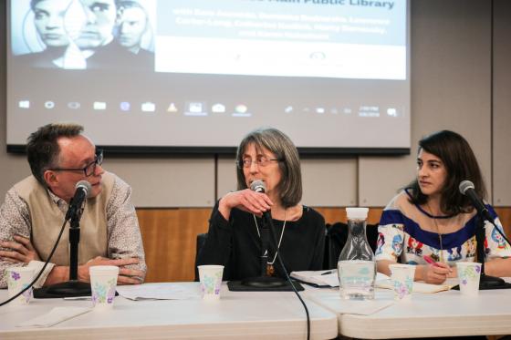 From left to write, Lawrence Carter-Long, Marcy Darnovsky, and Sara Acevedo sit at a table with microphones in front of them. Darnovsky looks at Carter-Long as she speaks, Acevedo looks toward them.
