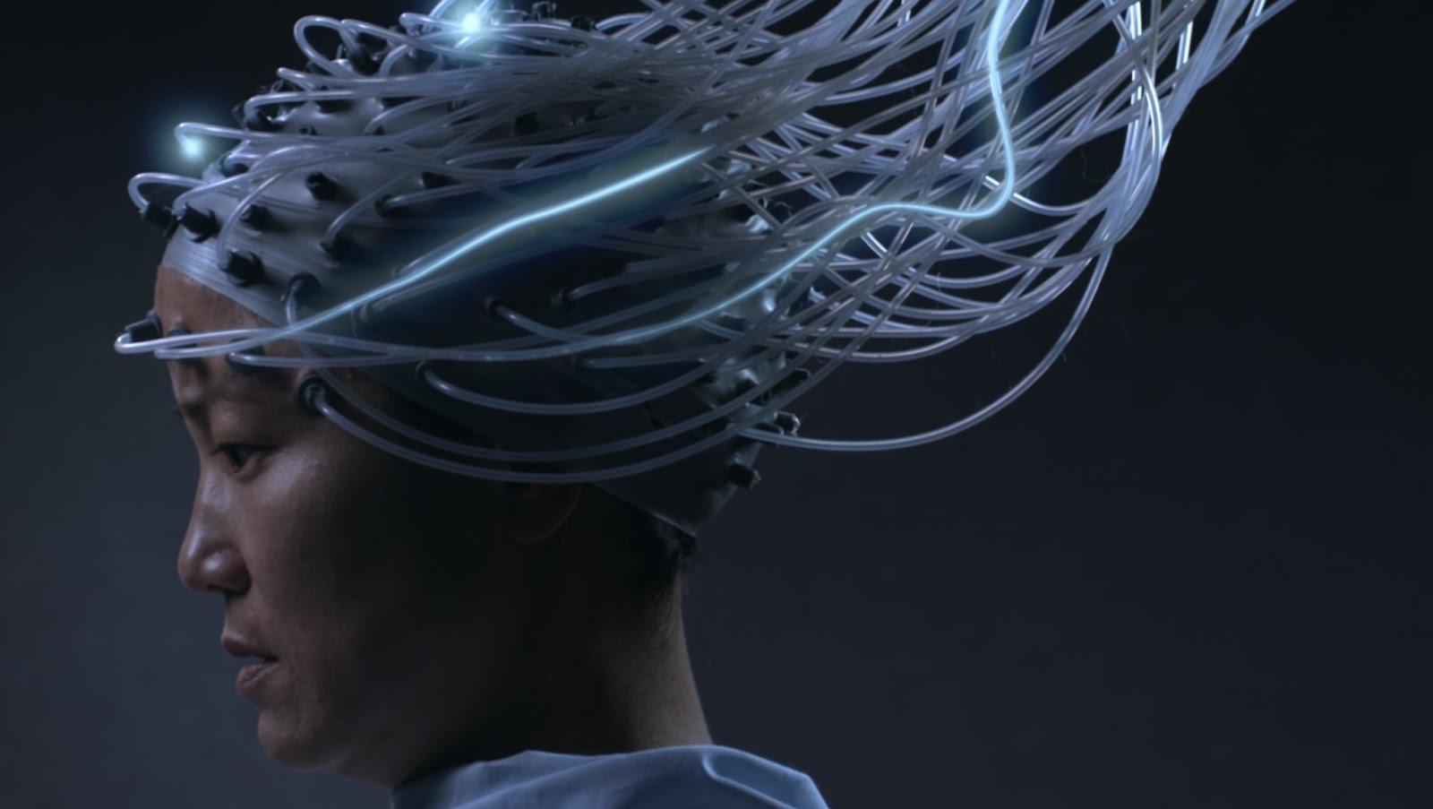 A still from the film Advantageous shows a woman with a sensory cap looks down (Youtube)