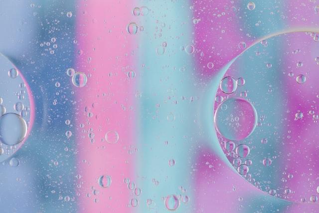 abstract bubbles over a fuzzy background of pink and blue stripes
