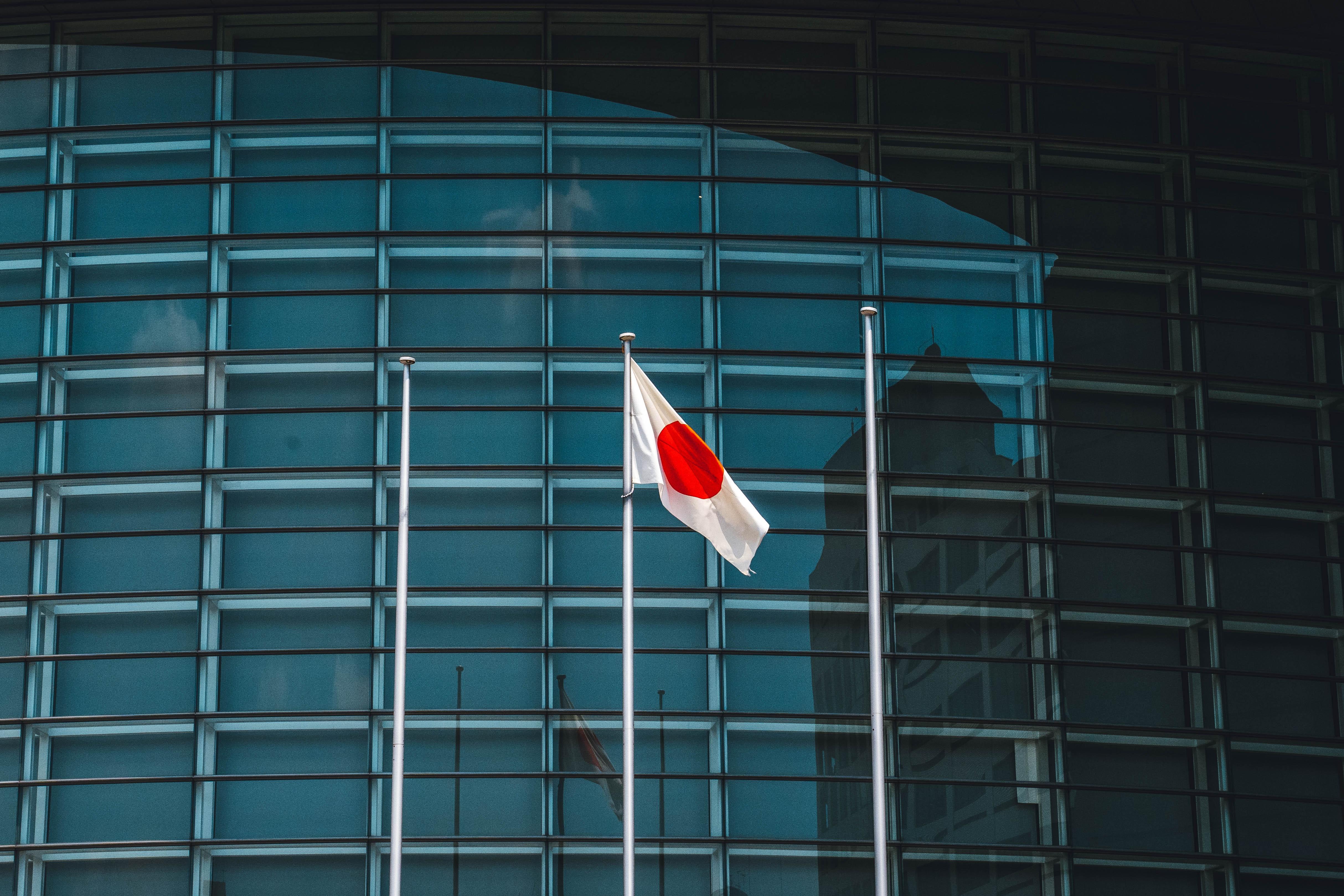 Japanese flag in front of a corporate building