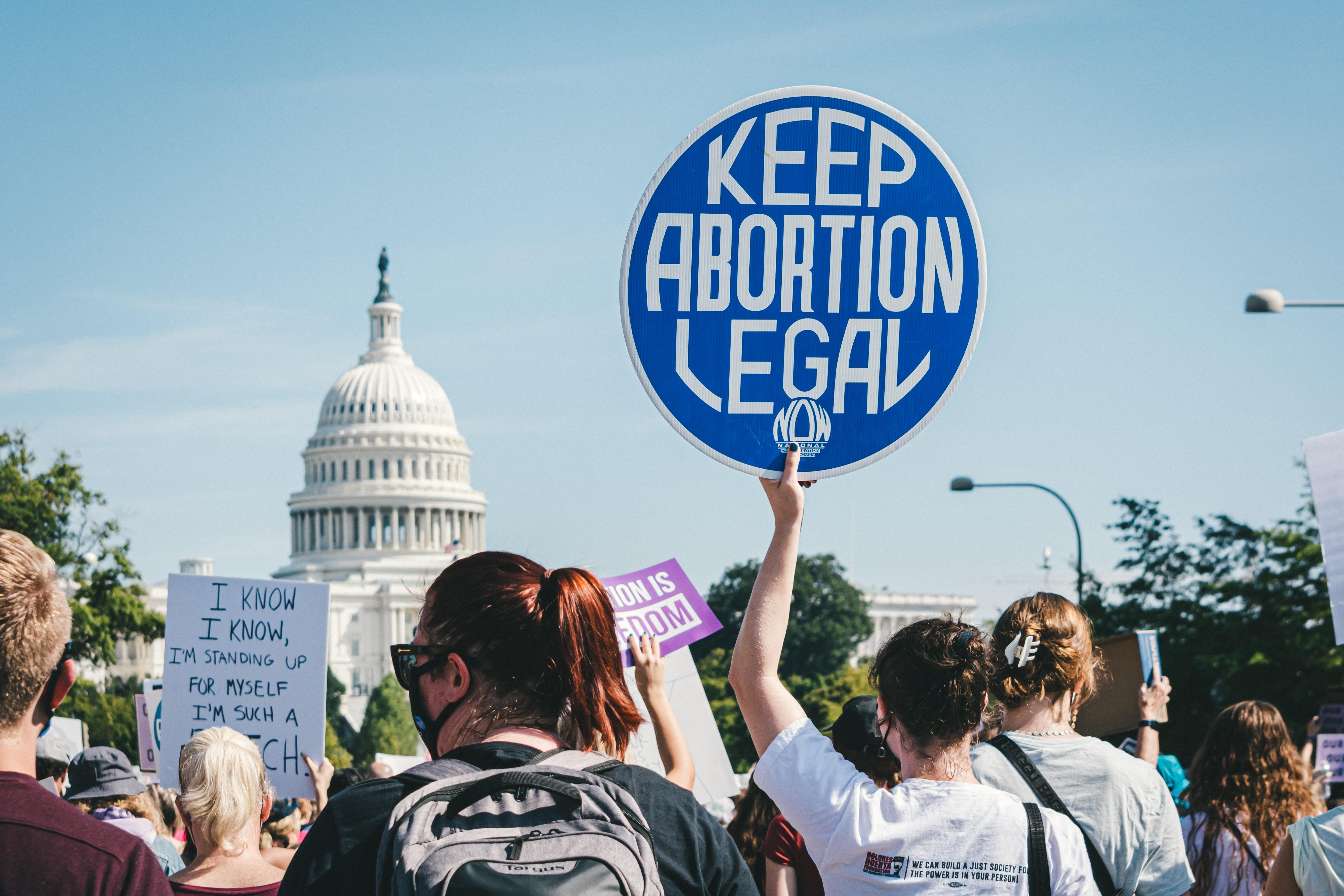 a protester holds up a sign saying "keep abortion legal"