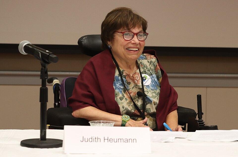 A photograph of Judith Heumann, as a panelist, ready to speak