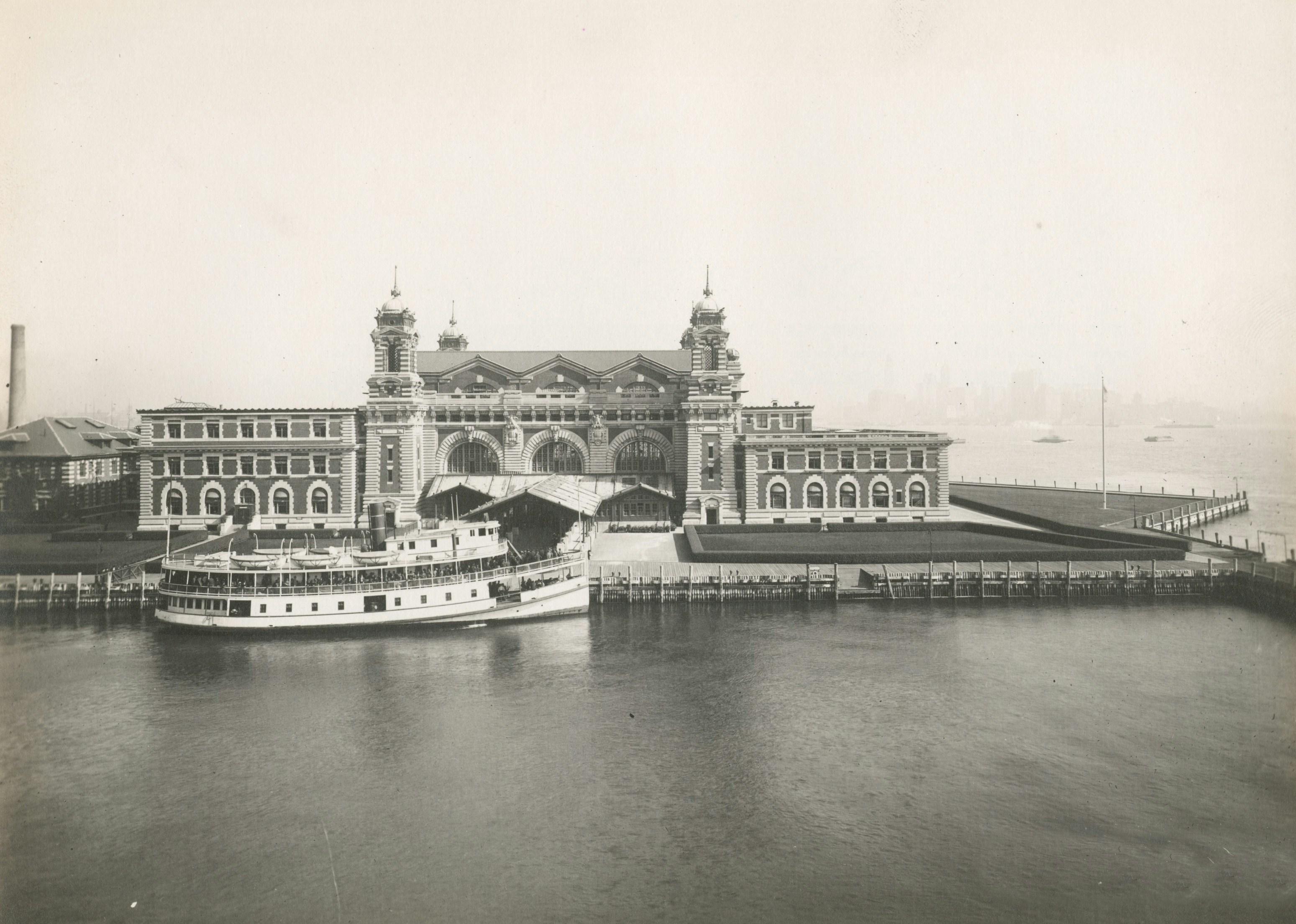 a grey and white photo of Ellis Island